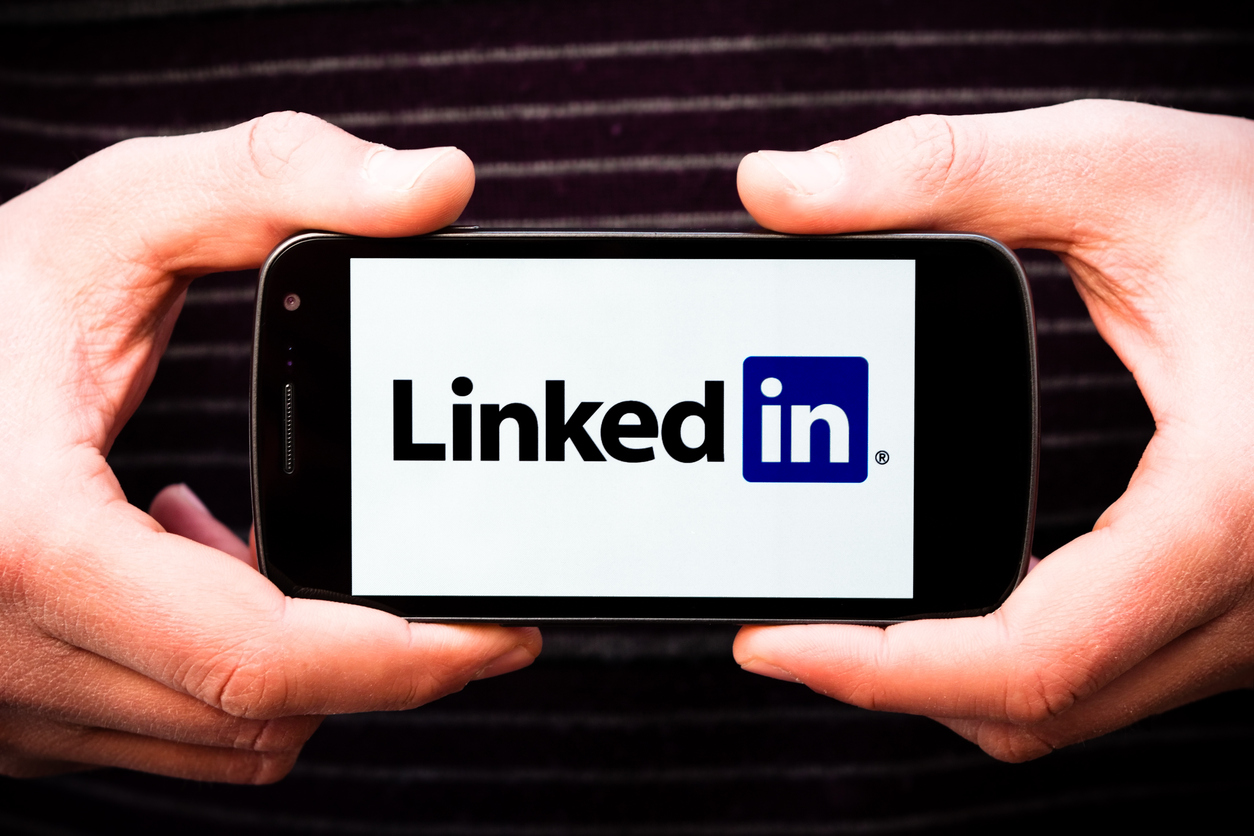 Florence, Italy - January 03, 2012: Two hands holding the Galaxy Nexus smartphone (made by Google and Samsung) showing the Linkedin logo. Linkedin is a social networking service used primarily for professional networking.